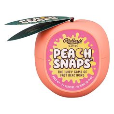 an orange plastic container with a green leaf sticking out of it's top that says peach snaps the juicy game of fast action