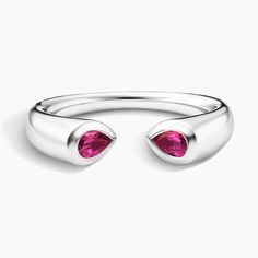 a pair of silver rings with pink stones