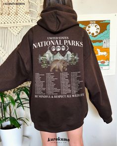 "This Unisex hooded sweatshirt features \"United States National Parks | Be Mindful & Respect All Wildlife\" with a complete list of the 63 National Parks in the U.S. and a gorgeous watercolor bear and mountain painting on the back and front. This sweater is perfect for raising awareness about adventuring responsibly as well as being a unique U.S. National Parks bucket list! Make sure to check out the other garment options below :) » O P T I O N S « ‣ Crewneck: https://www.etsy.com/listing/13300 Fall Fan Apparel Hoodie With Graphic Print, Cotton Hoodie With Graphic Print For Outdoor Activities, Cotton Hoodie With Letter Print For Outdoor, Cotton Hoodie With Graphic Print For Outdoor, Graphic Print Cotton Hoodie For Outdoor Activities, Fall Fan Apparel Hoodie With Letter Print, Fall Fan Apparel Hoodie With Adjustable Hood, Fall Fan Apparel Sweatshirt With Drawstring Hood, Outdoor Hoodie With Letter Print In Relaxed Fit