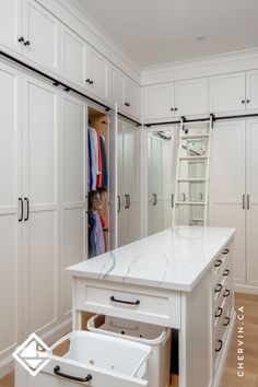 A white walk-in closet with a rolling ladder and Closet With Middle Island, Walk In Closet Seating Ideas, Master Closet Center Island, Closet Pull Out, Closet With Ladder Small Spaces, Master Closet With Island And Vanity, Walk In Closet Design Indian, Small Closet With Island, Walk In Closet Ideas Farmhouse