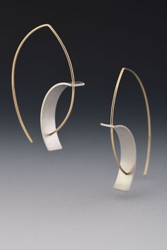 Tension Earring by Hilary Hachey. The convex earwire combined with the concave element create the tension for which this earring is named. The element is sterling silver, and it is available with a matte finish or an oxidized one. The ear wire shown is 18k yellow gold. Modern Yellow Gold Wrap Earrings With Ear Wire, Modern Yellow Gold Wrap Earrings, Modern Wrap Earrings For Formal Occasions, Modern Sculptural Jewelry With Polished Finish, Modern Sculptural Jewelry, Modern Metal Wrap Earrings, Modern Gold Earrings With Oxidized Finish, Modern White Jewelry, Modern Small Hoop Wrap Earrings With Ear Wire