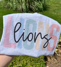 Go Lions! Lions design shirt printed on a unisex tee!  Shirt shown is ash.  All shirts printed on unisex Bella Canvas shirts. Lion Shirt Design, Cheer Spirit, Elizabeth Johnson, Mascot Shirt, Softball Shirt, Cheer Shirts, Lion Shirt, Lion Design, Spirit Shirts