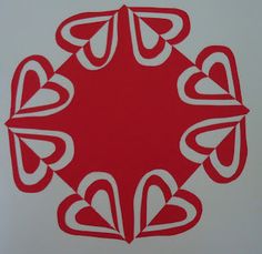 a red and white sticker on the side of a wall with hearts in it