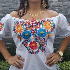 Beautiful colorful Hand Embroidered Mexican Flower Shirt made in Chiapas, Mexico. Cotton Shirt can be machine washed in cold water, hang to dry and warm iron. Each shirt is hand embroidered and flower will vary but each one is beautiful and unique Any questions please feel free to contact me DOES NOT INCLUDE THE BELT White Traditional Tops With Traditional Patterns, Festival Embroidered Multicolor Top, Traditional Multicolor Embroidered Top For Fiesta, Multicolor Bohemian Embroidered Top For Fiesta, Traditional Embroidered Multicolor Peasant Top, Traditional Embroidered Peasant Top For Beach, Traditional Summer Tops With Traditional Patterns, White Folk Tops With Woven Motifs, Festival Multicolor Top With Floral Embroidery