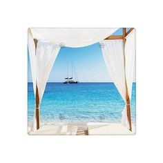 a sailboat is in the distance as seen from an open air gazebo with white drapes