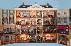 a large doll house with many rooms and windows