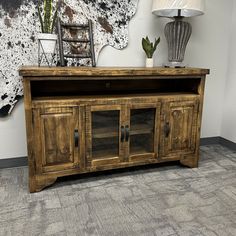 a large wooden entertainment center with glass doors