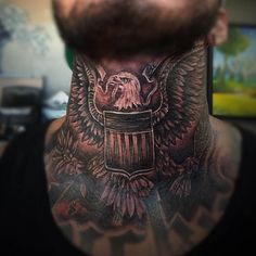 a man with a bald eagle and trash can tattoo on his neck is looking at the camera