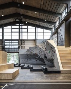 an indoor climbing wall and stairs in a building