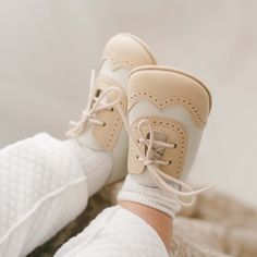 Baby wearing a pair of the Beige and Ivory Wingtip Shoes made with a tan and ivory matte leather with tan suede soles and detailed edging. Baby Dedication Outfit, Christening Gowns For Boys, Christening Gifts For Boys, Beautiful Compliments, Wingtip Shoes, Christening Outfit, Baby Boy Shoes, Boy Shoes, Tan Suede