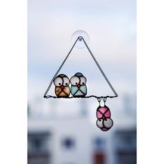 three little birds are hanging from a chain