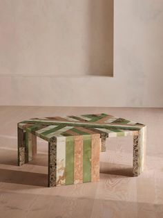 a coffee table made out of different colored blocks on top of a hard wood floor