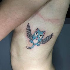 a small blue cat with wings tattoo on the side of his leg and chest is shown