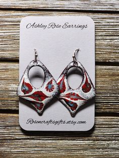 Open Diamond with Red, White, and Flowers; unique one of a kind enameled earrings. All products include exchange of equal or lesser value if in 30 days of purchase if front glass chips away noticeably showing copper.  Send me a picture of the earrings and your contact information. Red Bohemian Soldered Earrings, Bohemian Red Soldered Earrings, Artisan Nickel-free Red Earrings, Artisan Red Nickel-free Earrings, Artisan Red Jewelry With Artistic Design, Vintage Red Hand Painted Jewelry, Unique Red Earrings With Artistic Design, Red Hand Painted Earrings For Gift, Unique Artistic Red Earrings