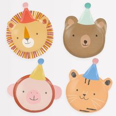 three paper plates with animals and hats on top of each plate, one has a lion, the other is a bear