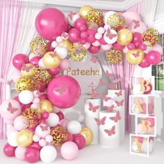 a bunch of balloons that are in front of a wall with the name pateeha on it