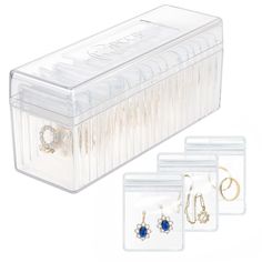 three pairs of earrings in a clear plastic box with earring hooks and jewelry clips