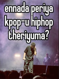 a man standing on top of a stage with his head in his hands and the words, ennada periya kpop - u hiphopp