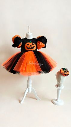 an orange and black tutule dress with pumpkins on it