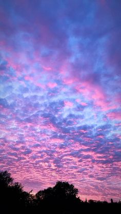 the sky is pink and blue with clouds