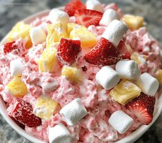 a bowl filled with fruit and marshmallows