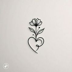 a heart shaped paper cut with a flower on the side and a leaf in the middle