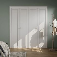 a bedroom with green walls and white closets