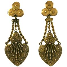 Wonderfully elegant Victorian Etruscan earrings from the late 19th Century in 14k gold. Intricate swirls and gold shot and bead work decorate the face. Beautiful gold work and craftsmanship. Exquisite quality and weight. Screw back fittings. 1870's USA. Excellent condition. 1.75" x .65".