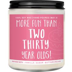 a jar of two thirty year olds candle with pink background and white lettering on it