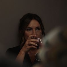 a woman holding a wine glass in front of her face