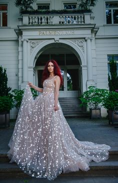 a woman in a dress is standing outside