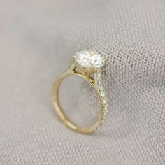 a close up of a diamond ring on a cloth