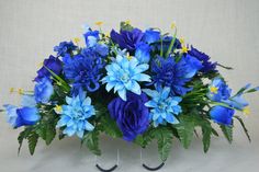 a bouquet of blue flowers in a metal stand