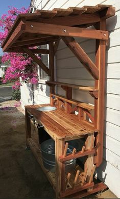 a wooden bench sitting next to a white house