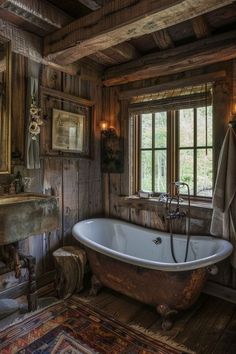 an old fashioned bathtub in a rustic bathroom with wood paneling and exposed lighting