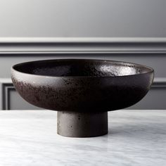 a black bowl sitting on top of a white counter