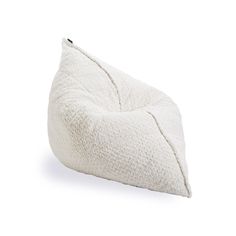 a white pillow sitting on top of a white floor