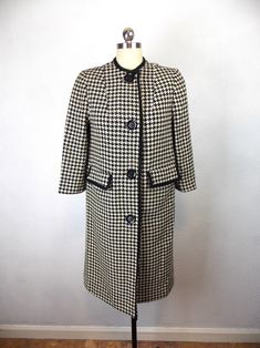 "Vintage 1950's 1960's woman's wool coat in a houndstooth pattern. Fully lined. Pockets. Three quarter length sleeves. Very good vintage condition. Length 36\" Shoulders 14\" Sleeves 3/4 length Bust 34\" Waist 36\" Hips 38\"/40\" Please note that vintage clothing and contemporary sizes can vary greatly. We take measurements of listed garments by laying the garment flat and then doubling the measurement. When considering whether a garment would fit, we suggest taking a similar garment from your own wardrobe and measure it lying flat as we do. Then compare the measurements." Vintage Tweed Outerwear For Office, Fitted Vintage Outerwear With Houndstooth Pattern, Vintage Houndstooth Outerwear For Winter, Vintage Plaid Outerwear For Office, Vintage Wool Houndstooth Outerwear, Wool Houndstooth Vintage Outerwear, Vintage Houndstooth Outerwear, Tennis Sweater, Houndstooth Coat