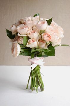 a bouquet of pink roses on a white table