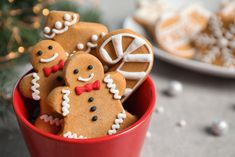 a red cup filled with lots of cut up gingerbreads on top of a table