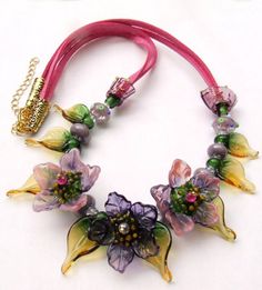 the necklace is decorated with flowers and beads