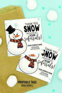 two snowman cards on top of a brown envelope