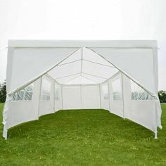 a white tent set up in the grass