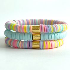 multicolored bracelets with gold accents on white background, close up view from the front