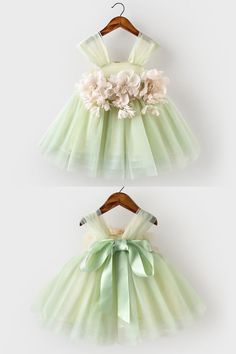 two dresses with bows and flowers on them, one is green and the other is white