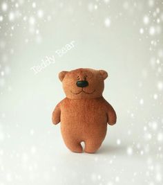 a brown teddy bear sitting on top of a snow covered ground with the words teddy pear above it