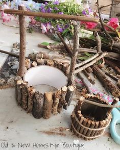 a pile of wood sitting on top of a wooden table next to flowers and scissors