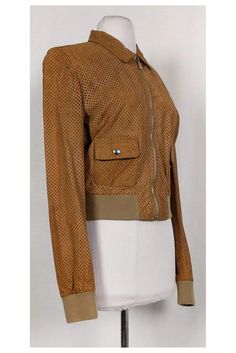 Elevate your look with this chic jacket. Its rich tan color pairs well with solid neutrals. The leather is made with a perforated design that gives it a unique. It is a perfect piece for all year wear. Size US 8 - IT 44 Lambskin leather & cotton Made in Italy Silver-tone hardware Zip front Front pockets Lined Perforated design on leather Some wear on under arm area Light wear on interior lining Bust 37" Waist 31" Long sleeve 20" Designer Brown Leather Jacket With Zipper, Designer Brown Leather Jacket With Zipper Closure, Designer Brown Leather Jacket For Spring, Spring Brown Leather Jacket, Brown Leather Jacket For Spring, Fitted Designer Brown Leather Jacket, Designer Fitted Brown Leather Jacket, Chic Jacket, Color Pairs