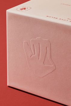 a pink box that has some kind of hand on it