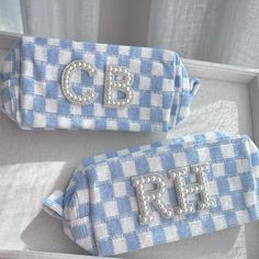 two blue and white gingham bags with the letters cbp on them are sitting next to each other